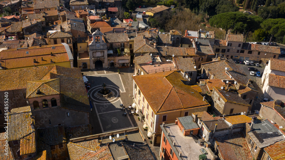 Aerial view of the town square of Sutri, a small city near Viterbo and Rome, Italy. All houses and buildings have traditional red tiled roofs.
