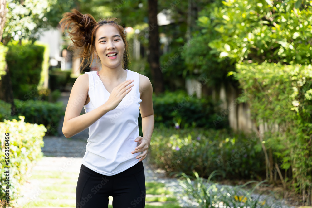 Young woman running in summer, green city environment with fresh clean air Young woman running in summer, green city environment with fresh clean air