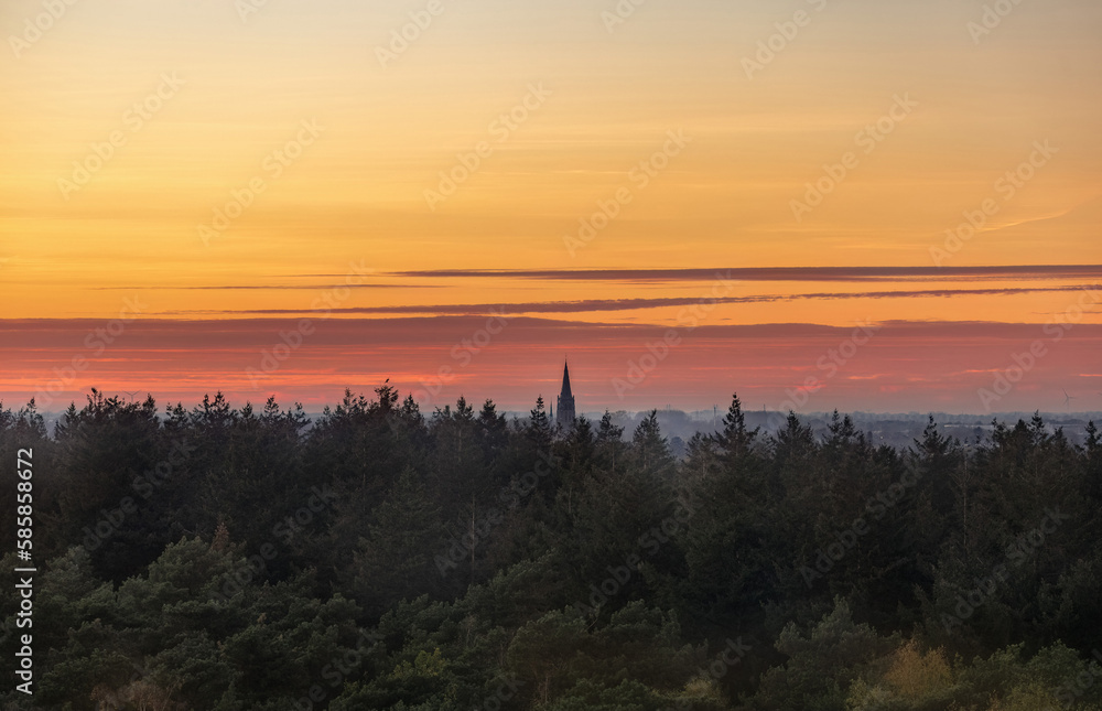 A beautiful sunset over the woods photographed from a lookout tower in the woods