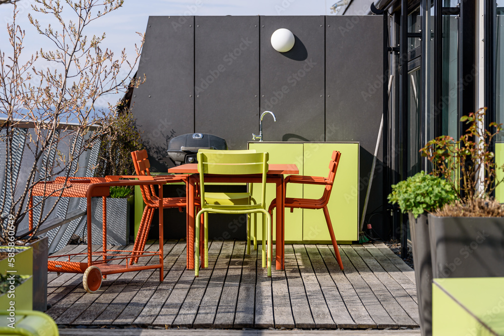 Rooftop terrace with green and terracotta furniture in Vienna
