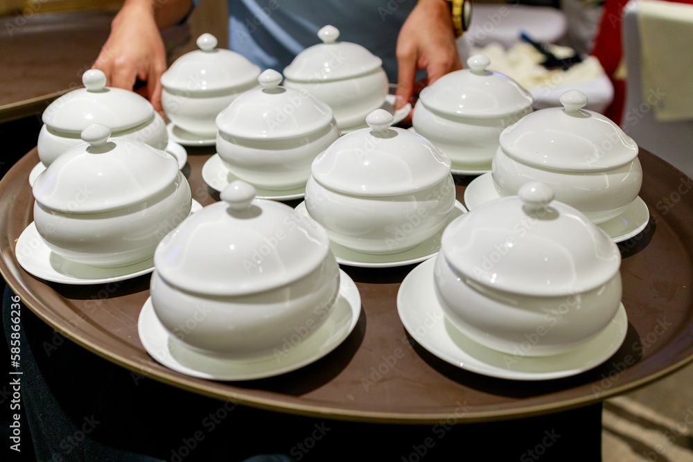 Close up of waiter serving soup bowl in a restaurant. Close up of waiter serving soup bowl in a restaurant.