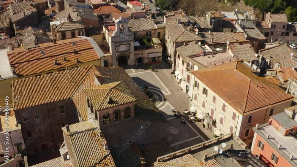 Aerial view of the town square of Sutri, a small city near Viterbo and Rome, Italy. All houses and buildings have traditional red tiled roofs. Aerial view of the town square of Sutri, a small city near Viterbo and Rome, Italy. All houses and buildings have traditional red tiled roofs.