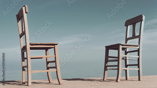 Empty two wooden chairs on pier on blue sky background. Vintage effect photo.
