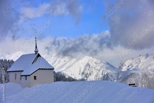 snowy chapel Maria in the mountains