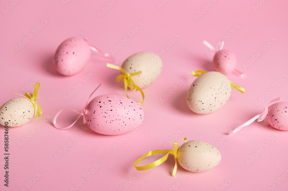 Close-up studio shot of beige and pink pastel Easter eggs on isolated pink background with copy advertising space. Still life. Easter celebration concept. Top view