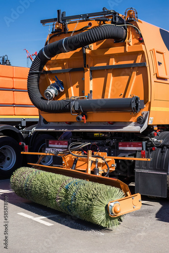 car for cleaning roads with round brushes. special vehicle for cleaning the road from dirt. mechanism of municipal sweeper