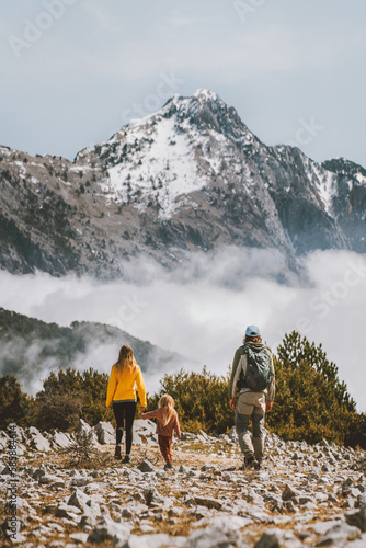 Family hiking in mountains parents with child travel outdoor active healthy lifestyle summer vacations eco tourism in Albania mother and father with kid trekking