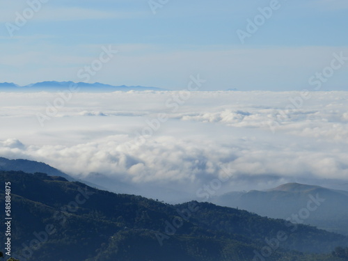 Enveloped in Majesty  The Serenity of Clouds Draping Over Majestic Mountains