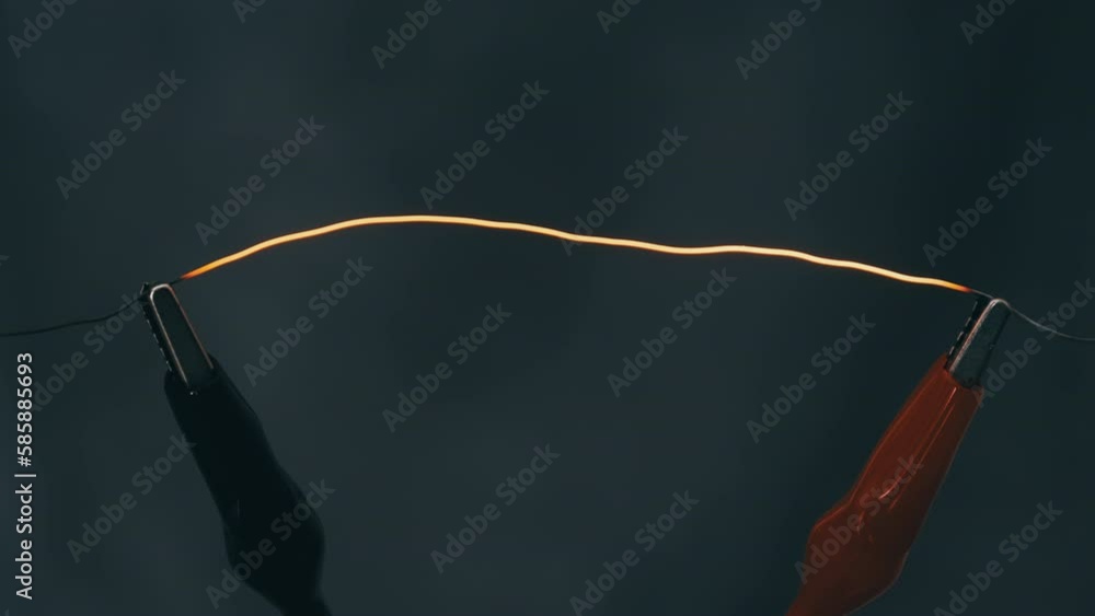 Nichrome filament connected to power wires is heated to red under high