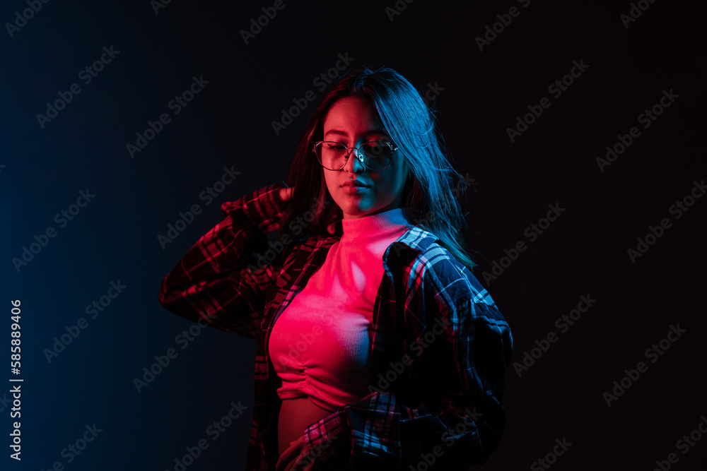 Dreamy woman in neon illumination in darkness Dreamy woman in neon illumination in darkness