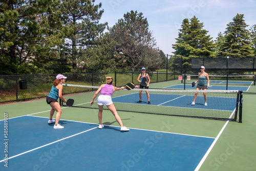 Pickleball Players in Action at Net © pics721