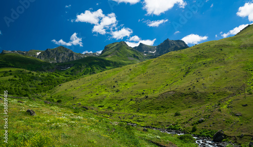 Mountain landscape in spring season. Beautiful clear day with streams flowing from mountains and green hills