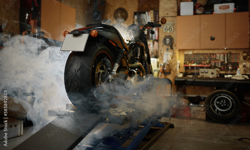Motorcycle in clouds of smoke standing in biker or motorcyclist garage