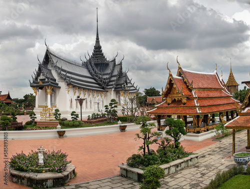 Panoramic photo of the architectural park of Oriental culture. Religious buildings of Thai history: palace and temple complexes. The exhibits are surrounded by ponds, tropical greenery and flowers