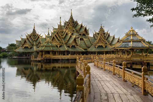 Panoramic photo of the architectural park of Oriental culture. Religious buildings of Thai history: palace and temple complexes. The exhibits are surrounded by ponds, tropical greenery and flowers