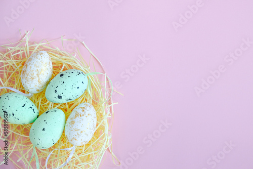 Colored Easter eggs on a pink background. Top View. Space for text, banner