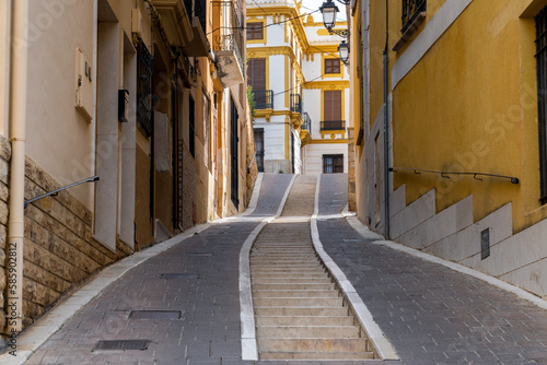 Narrow cobbled street in Polop town, Alicante, Spain photo