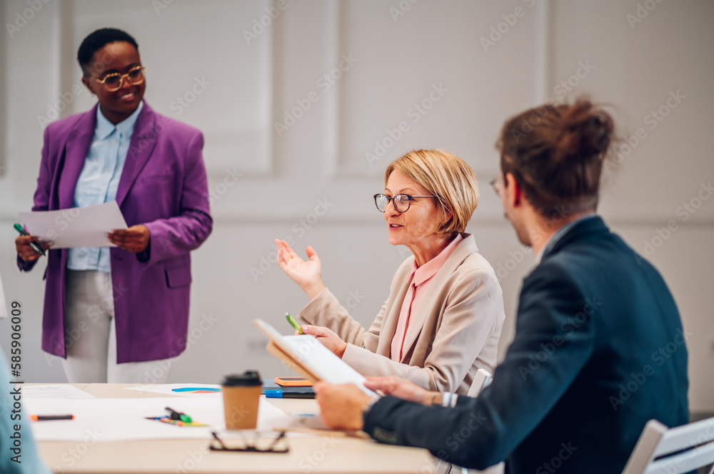 Multiracial business group of people having a meeting in an office Multiracial business group of people having a meeting in an office
