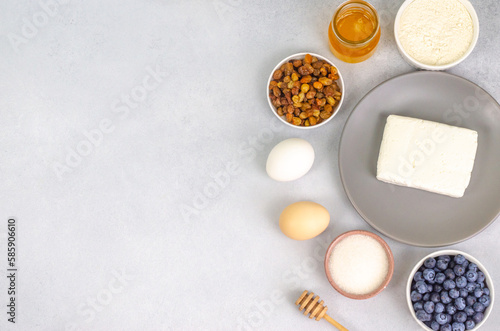Products for the preparation of cheesecakes on a light background with a place for text.