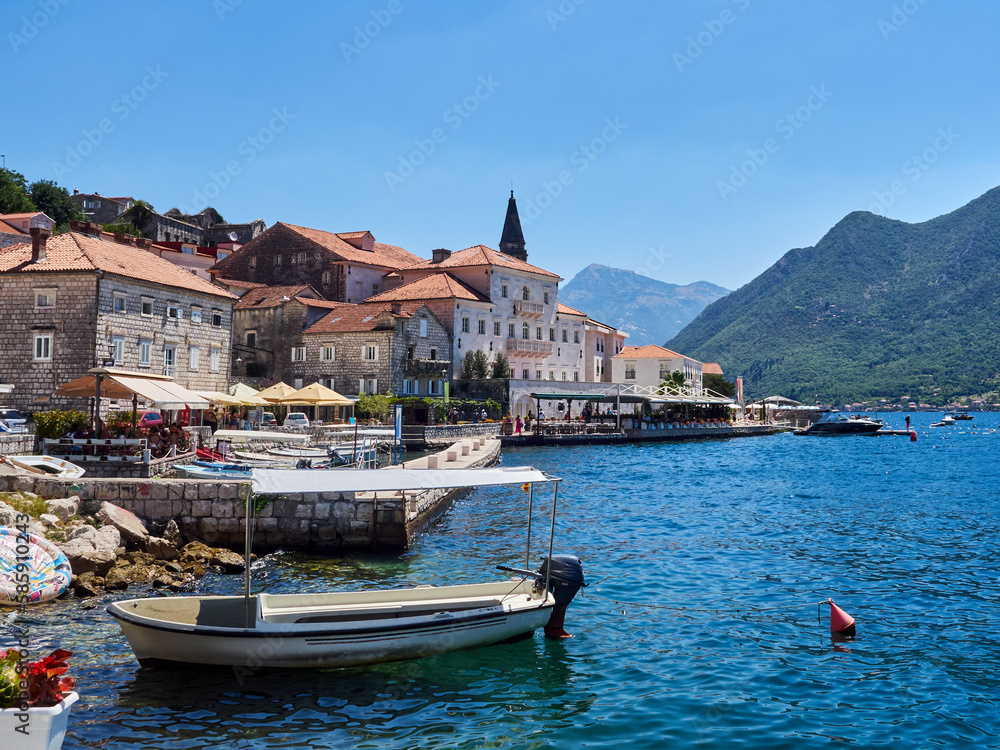 View of the touristic village of Perast, with boats in the harbour, a baroque palace and the tower of the church. Vacations in the Adriatic sea, Montenegro, Europe