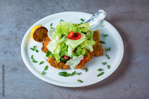 Veal Milanese with salad served in dish isolated on grey background top view of bahrain food