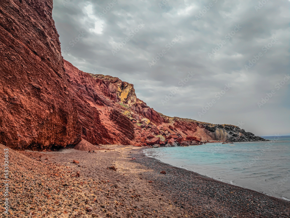The famous Red Beach, Kokkini Paralia in Santorini island, Greece. Unique red sand beach on a cloudy day
