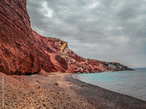 The famous Red Beach, Kokkini Paralia in Santorini island, Greece. Unique red sand beach on a cloudy day