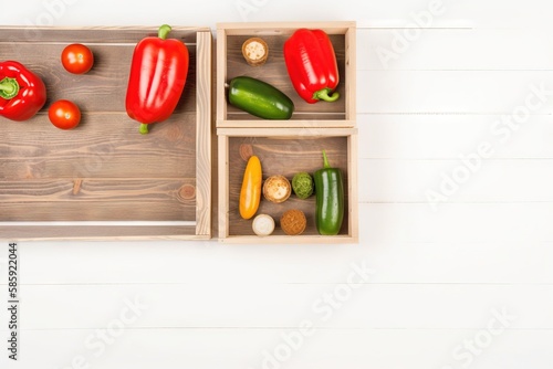  a wooden box filled with different types of vegetables on a white table top next to a wooden box filled with peppers and other fruits and vegetables. generative ai