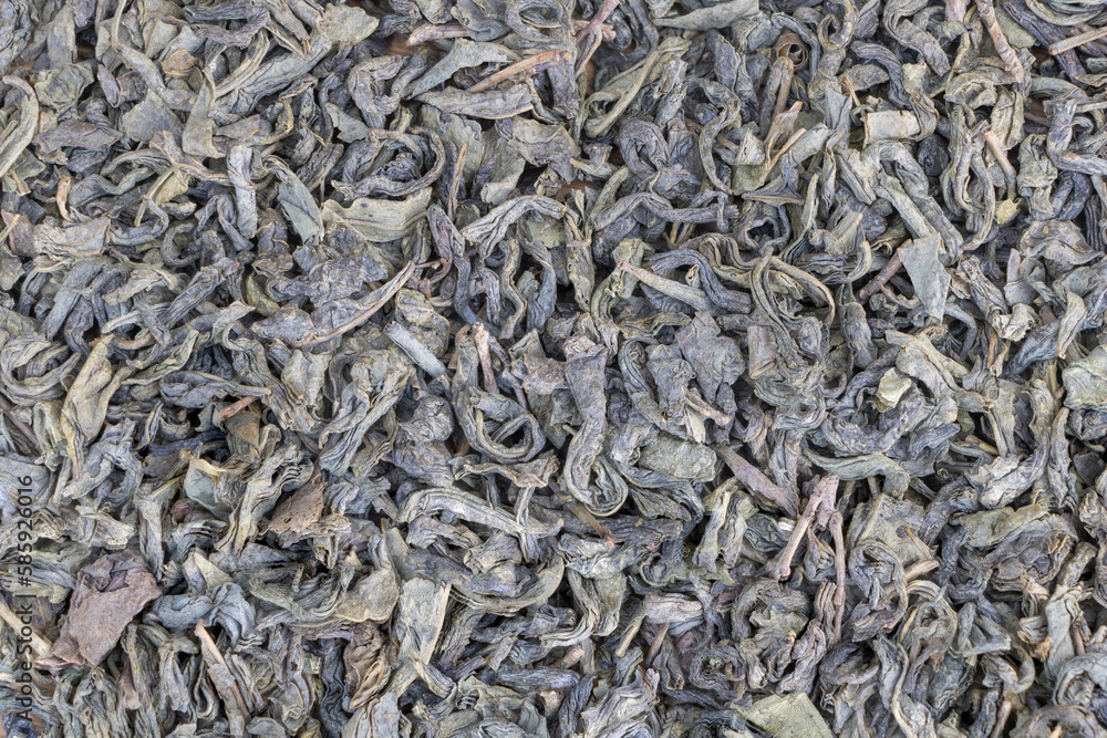 Dry green tea leaves as background. Close up. Top view Dry green tea leaves as background. Close up. Top view
