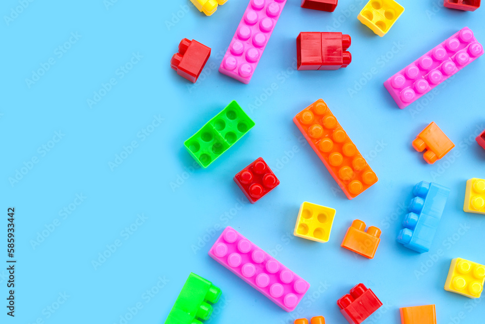 Plastic building blocks on blue background. Plastic building blocks on blue background.