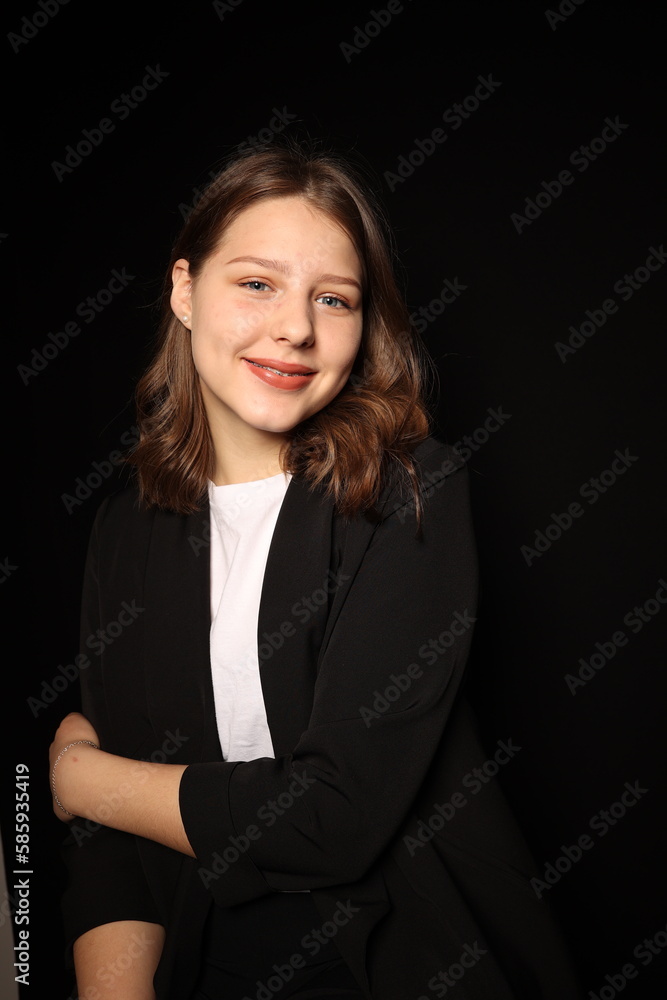 portrait of a beautiful young brunette woman in a black blouse on a black background. strict portrait of a girl on a black background portrait of a beautiful young brunette woman in a black blouse on a black background. strict portrait of a girl on a black background