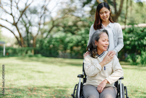 Family relationship, Asian senior woman in wheelchair with cheerful daughter spending time together