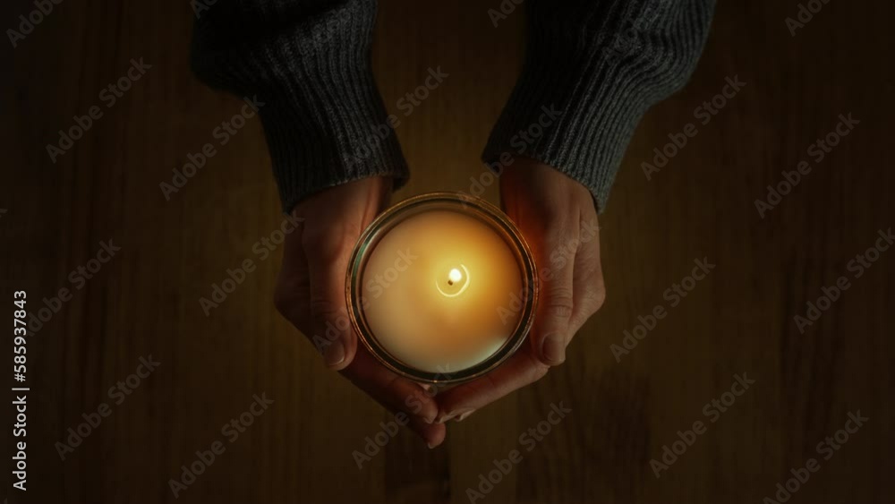 custom made wallpaper toronto digitalFemale hands holding candle appear in the frame, over a wooden table background. Moment of sorrow and grief. Spiritual significance of holy sacrament brings peace and meditation, inspiring to pray.