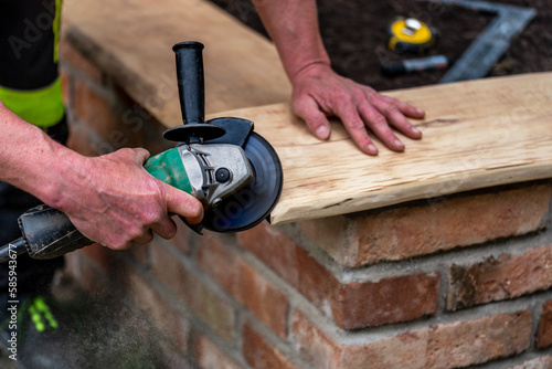 A carpenter works in a garden.