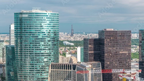 Paris skyline and skyscrapers with Eiffel Tower and park timelapse from the top of the towers in Paris business district La Defense. Sunny summer day. Paris, France photo