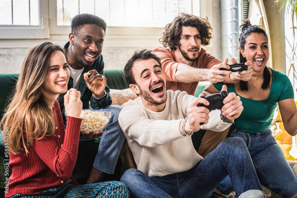 Happy multi ethnic friends sitting on sofa playing video games - Cheerful generation z group having fun with modern technology videogames - Hobby and tech concept - obrazy, fototapety, plakaty 