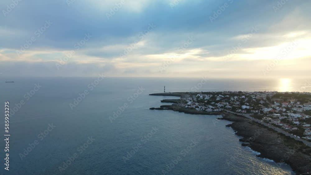 Waves rolling along the coastline as drone flys past with sun dropping below the horizon at sunset. Waves rolling along the coastline as drone flys past with sun dropping below the horizon at sunset.