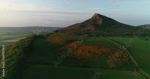 Drone footage of Roseberry Topping and Aireyholme Farm, North Yorkshire England. The childhood home of Captain James Cook. The gorse in full bloom beneath Roseberry Topping. photo