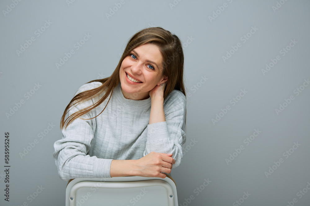 Portrait of woman sitting on chair back view. Portrait of woman sitting on chair back view.