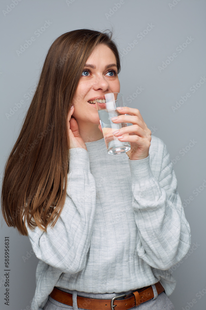 Portrait of young woman holding water glass and looking at side. Portrait of young woman holding water glass and looking at side.
