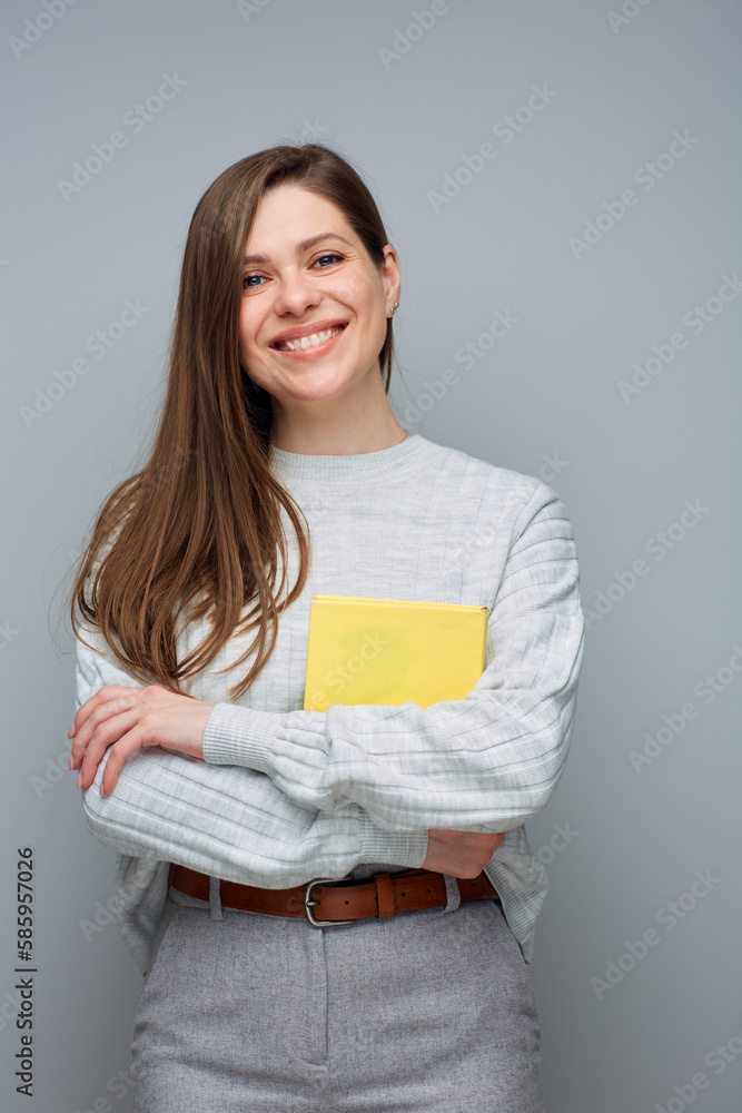 Smiling woman holding yellow book. Isolated portrait. Smiling woman holding yellow book. Isolated portrait.