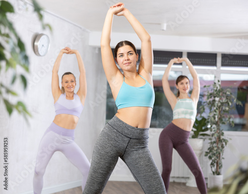 Young sports woman engaged in dancing in fitness studio