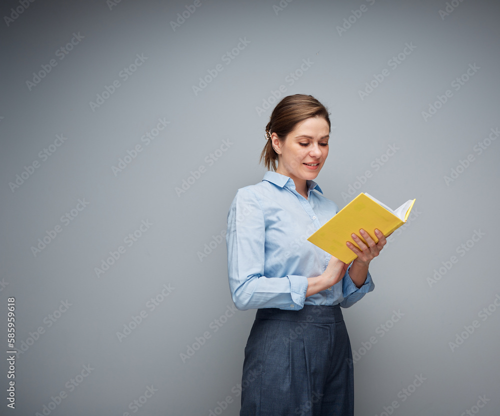 Smiling teacher or student girl reading book, young woman holding book, female portrait.. Smiling teacher or student girl reading book, young woman holding book, female portrait..
