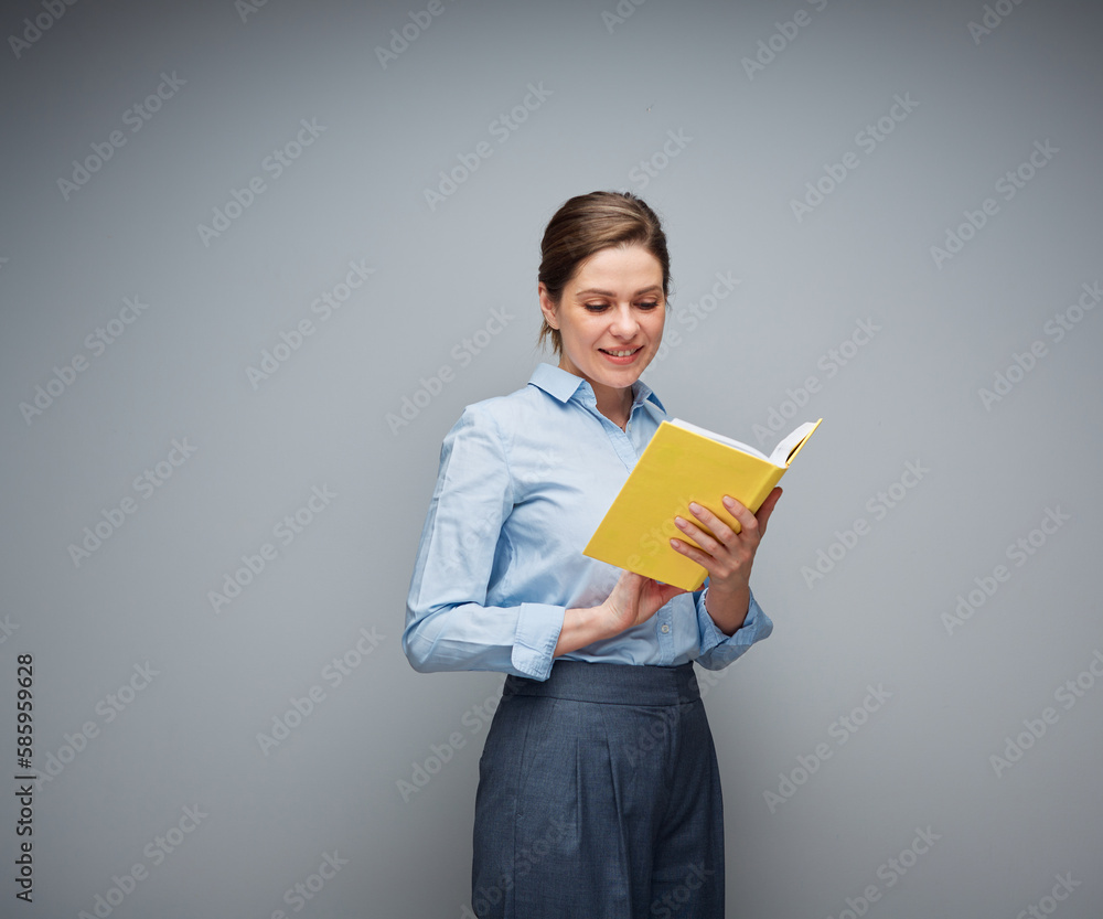Smiling teacher or student girl reading book, young woman holding book, female portrait.. Smiling teacher or student girl reading book, young woman holding book, female portrait..