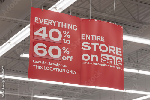 Store clearance and discount signs displayed at a soon to be out of business retail location. 40 to 60 percent discount.