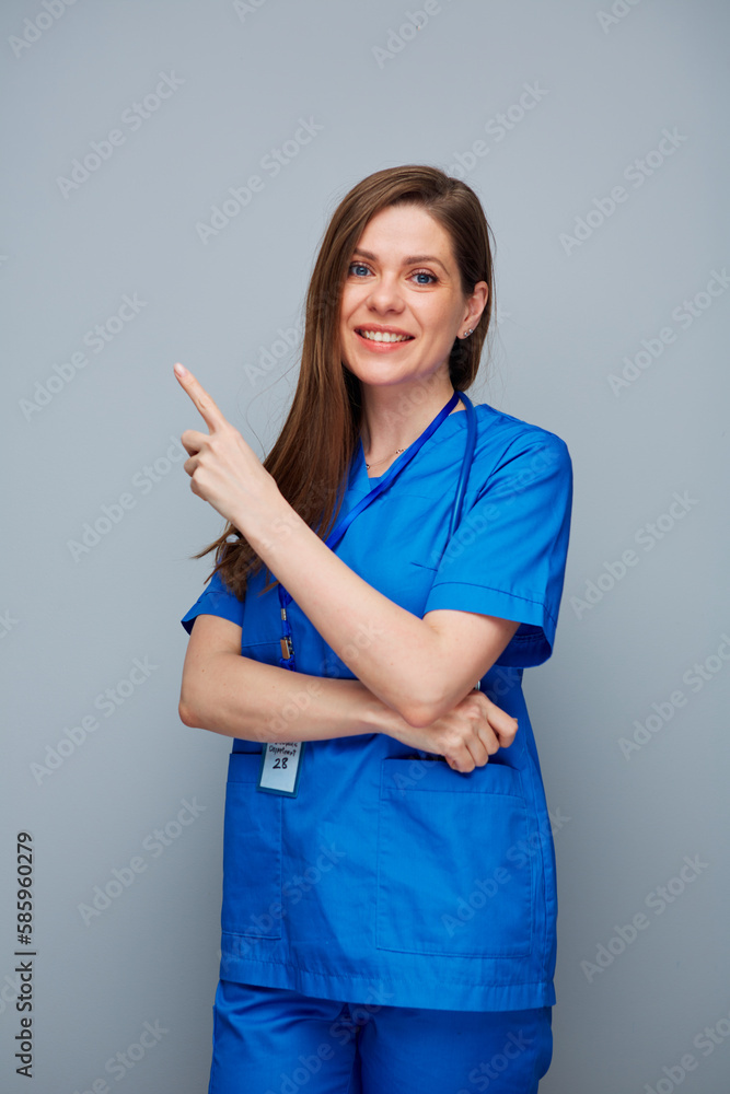 Smiling doctor woman or nurse pointing finger up. Smiling doctor woman or nurse pointing finger up.