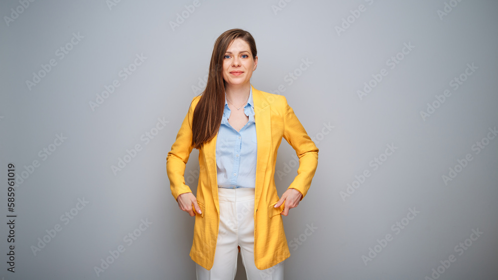 Real confident woman with real emotion in yellow jacket on gray background Real confident woman with real emotion in yellow jacket on gray background