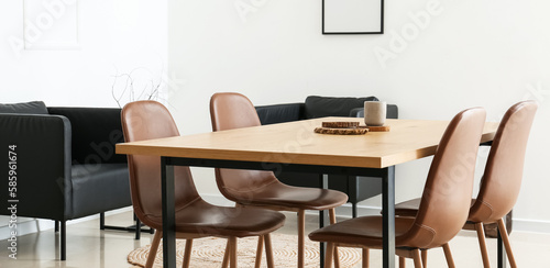 Interior of modern dining room with wooden table and brown chairs