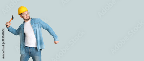 Male worker with hammer on ...