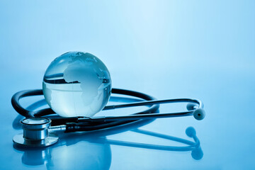 World Health Day. Global Health Awareness Concept. Globe and Stethoscope on blue background.